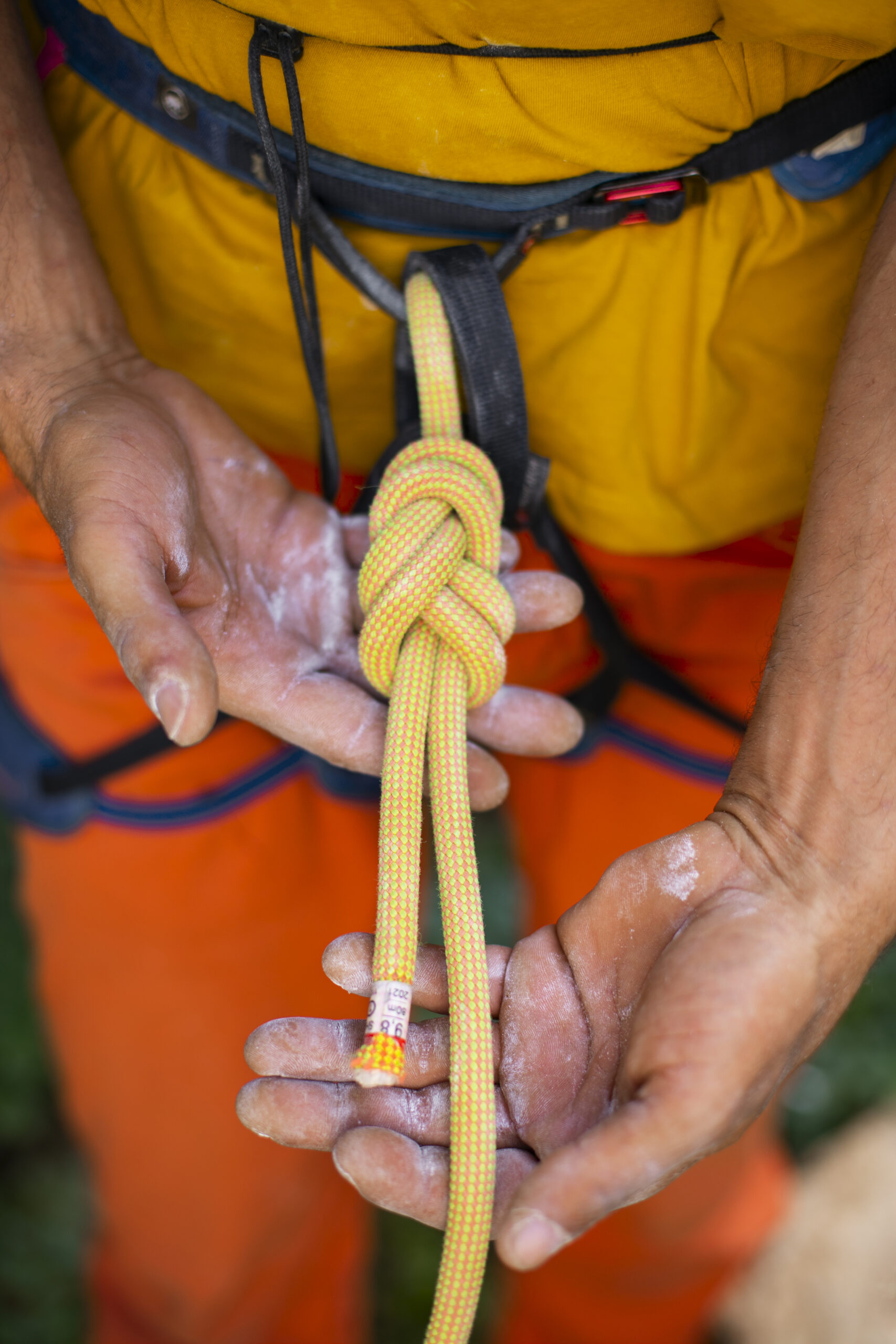 man holding figure eight knot for climbing